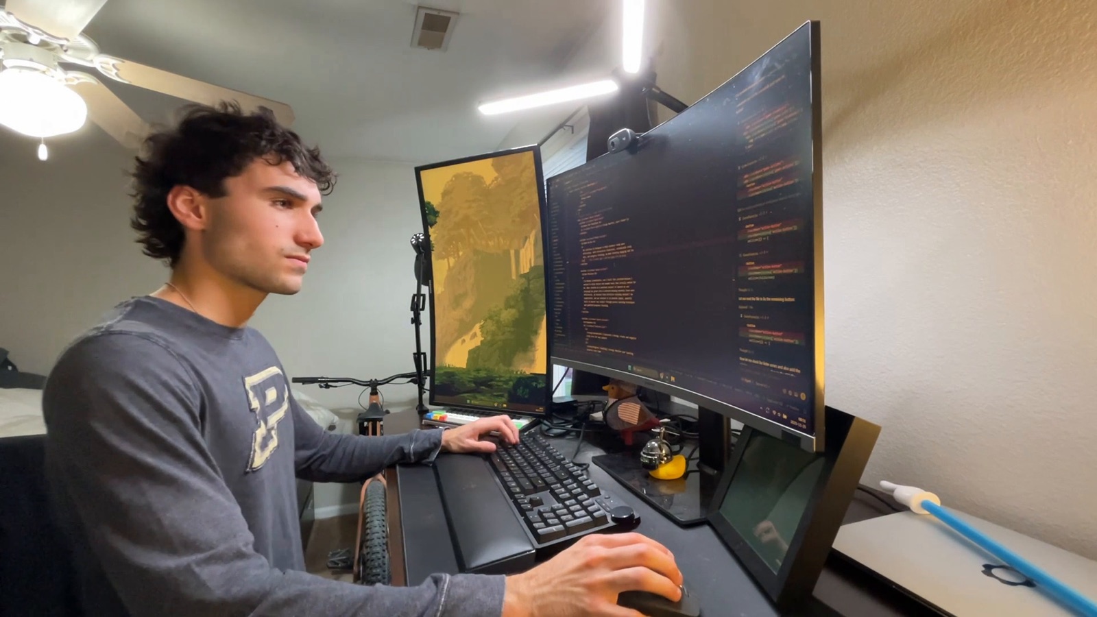 Maddox Schmidlkofer at a desk working on DuckMath across two monitors